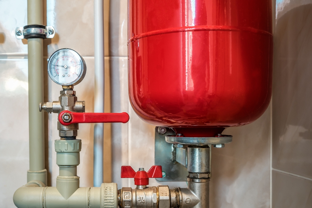 Red expansion tank and the hot water system pipes